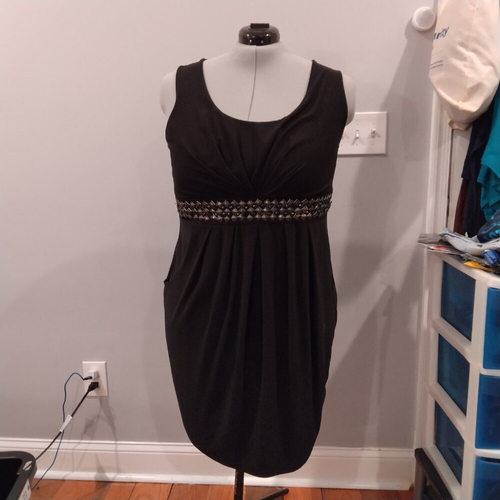 Black dress with gold metal adornment pieces as belt